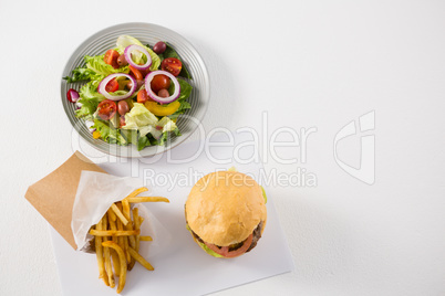 High angle view of salad with burger and French fries