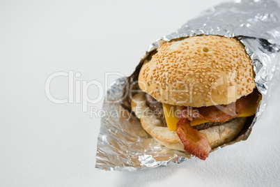 Close up of burger wrapped in foil paper