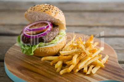 French fries with hamburger on cutting board