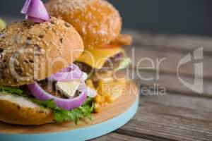 Close up burgers on cutting board