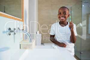 Portrait of smiling boy showing toothbrush