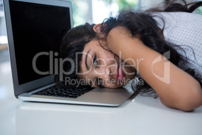 Portrait of girl leaning on laptop