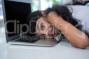 Portrait of girl leaning on laptop