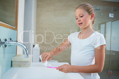 Girl removing toothpaste on brush