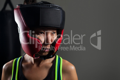 Determined woman wearing headgear during boxing