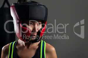 Determined woman wearing headgear during boxing