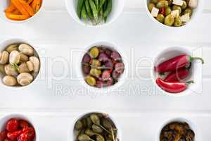 Marinated olives and vegetables on white background