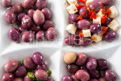 Marinated olives with herbs and spice in plate