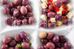 Marinated olives with herbs and spice in plate
