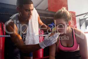 Trainer applying cream on woman face