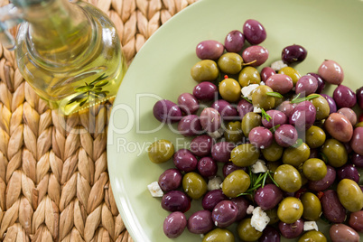 Marinated olives with olive oil on bamboo mat