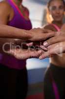 Close-up of athletes stacking hands