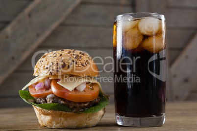 Hamburger and cold drink on table