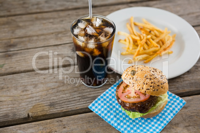 High angle view of hamburger with drink and french fries