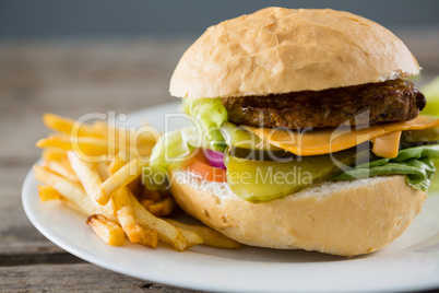 Close up of cheese burger with french fries