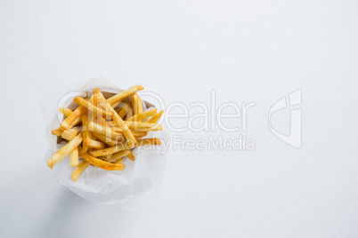 Overhead view of French fries in paper bag