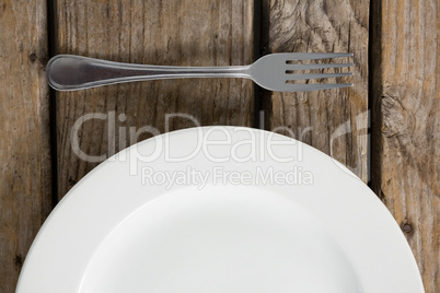 Cropped image of plate by fork