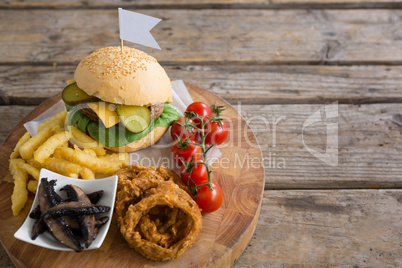 High angle view of vegetables with fried food by burger