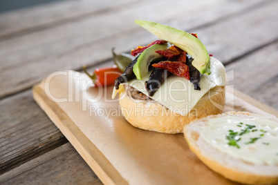 Close up of vegetables with cheese and bun