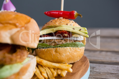 Close up of burger with jalapeno pepper and french fries