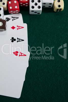 Various dice and playing cards on poker table