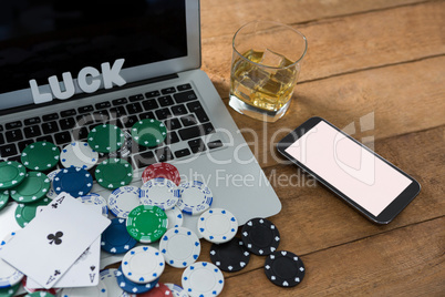High angle view of scattered chips and aces with technologies