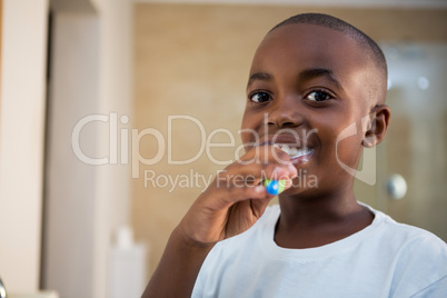 Close-up portrait of smiling boy with toothbrush