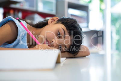 Close-up of girl writing in book