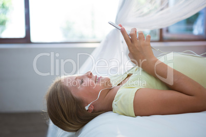 Girl listening music while using smartphone