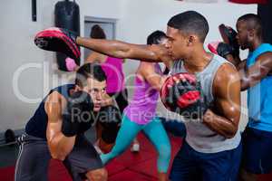 Boxer defending with male instructor