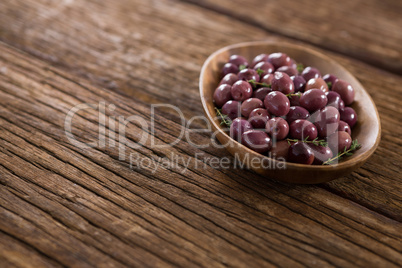 Marinated olives in wooden bowl
