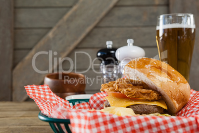 Close-up of burger and glass of beer