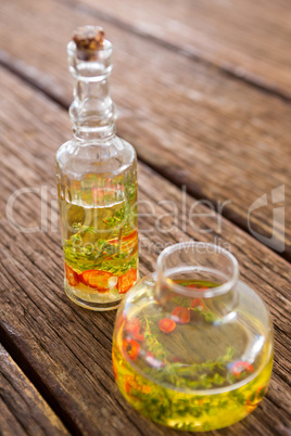 Olive oil with rosemary and red chili pepper in container