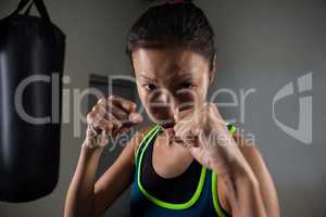 Woman practicing boxing in fitness studio