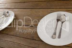 White plate with cutlery on table