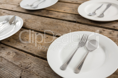 Close up of spoons and forks in plate