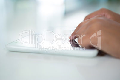 Close-up of girl touching digital tablet