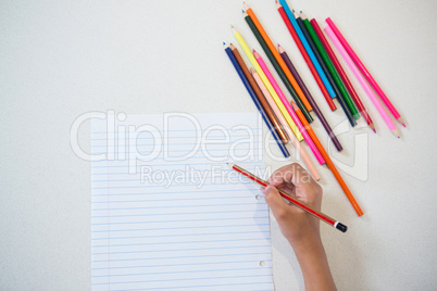 Overhead view of girl drawing on paper