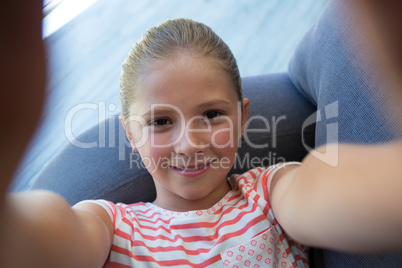 High angle portrait of girl lying on sofa