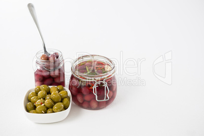 Pickled olives in jar and bowl