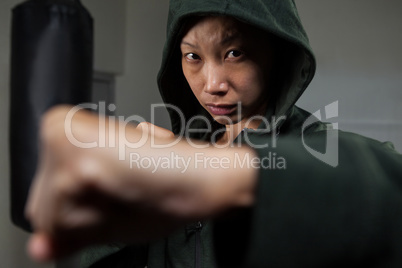 Determined woman practicing boxing in fitness studio