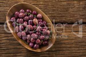 Marinated olives in wooden bowl