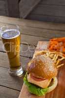 Burger and french fries with glass of beer