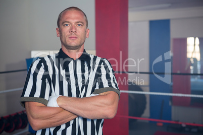 Portrait of male referee standing in with arms crossed