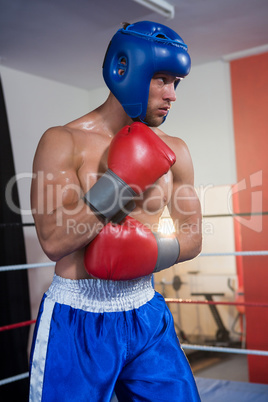 Young male boxer wearing blue headgear