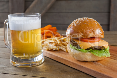 Burger and french fries with glass of beer