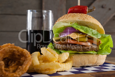 Hamburger, french fries and cold drink on table