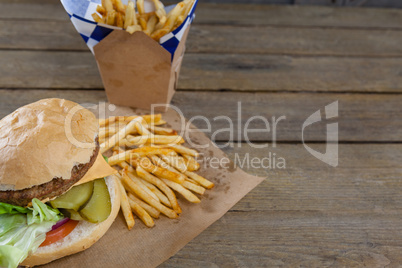 Close-up of hamburger and french fries in take way bag
