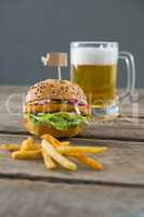 Close up fries with burger and beer glass