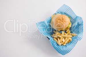 Directly above shot of burger and French fries in napkin